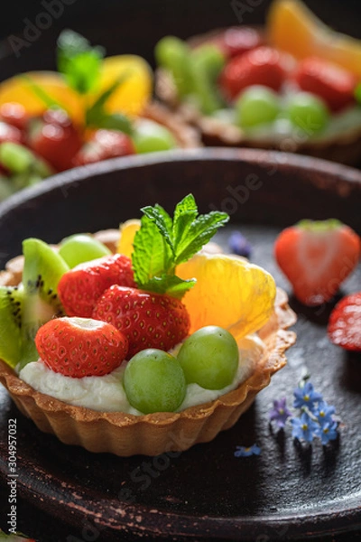 Fototapeta Sweet mini tart with mix of fruits and cream