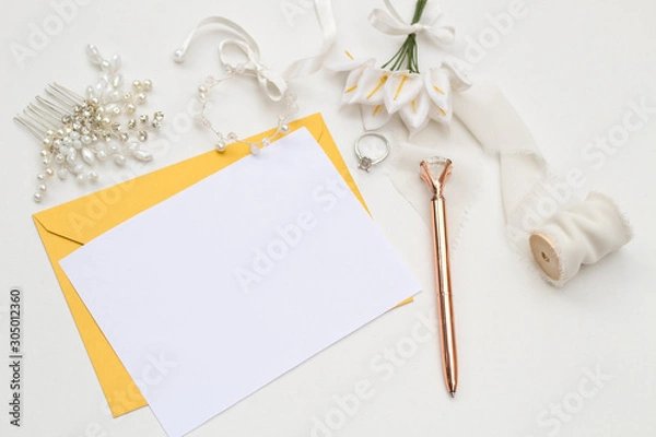 Fototapeta Flat lay shot of letter and eco paper envelope on white background. Wedding invitation cards. Valentine's day or other holiday concept, top view, flat lay, overhead view