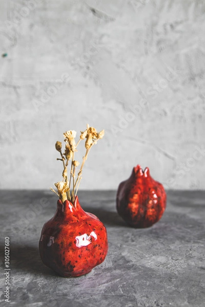 Fototapeta Pomegranate vase on a gray background. Vintage style