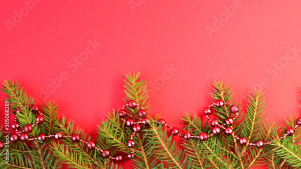 Obraz Christmas composition Christmas decorations, fir branches with a red background. Flat design, side view, copy space.