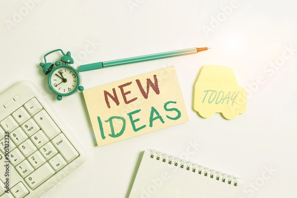 Fototapeta Word writing text New Ideas. Business photo showcasing something original or fresh and more effective innovation Copy space on empty note paper with clock and pencil on the table