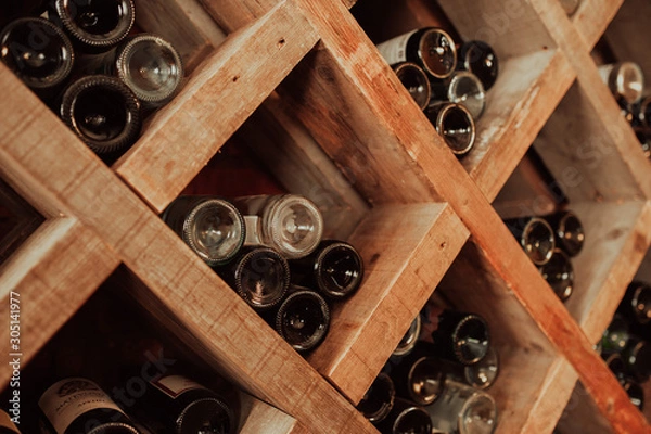 Fototapeta dark wooden storage cabinet for bottle with plenty of empty bottled glass
