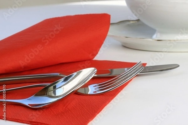 Obraz cutlery on red napkin