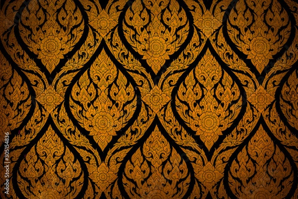 Fototapeta Closeup Thai pattern carving lotus picture at door in temple