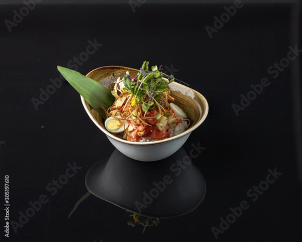 Fototapeta Salmon poke Salmon, avocado, rice, sesame, cashew, sesame sauce, ginger, carrot, green onion, quail egg, tobiko caviar, orange