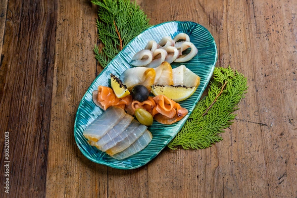 Fototapeta Cold fish appetizers: Lightly salted omul. Muksun is slightly salted. Cold smoked butter. Salted salmon