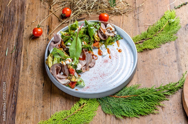 Fototapeta roast beef salad with baked vegetables and feta cheese