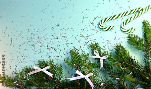 Obraz New Year card with Christmas and holiday decorations, sweets, on a blue background. Christmas template for banner, ticket, brochure, card, invitation, poster, etc. Place for text.