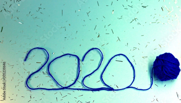 Obraz New Year 2020 blue festive background with thread tied with a blue ribbon. New Year 2020 concept. Selective focus, defocused view.