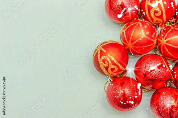 Fototapeta Christmas background with copy space. Top view of Christmas red balls on light blue background. Copy space.
