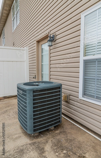 Obraz Air Conditioning Unit on Patio Behind Condo