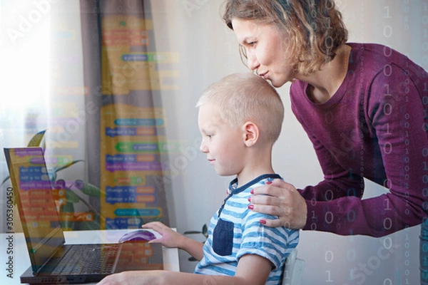 Obraz Young programmer writing code on a computer together with his mom or teacher. Programming lessons for kids.