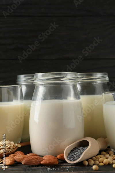 Fototapeta Glasses with diferent types milk on wooden background, space for text. Closeup
