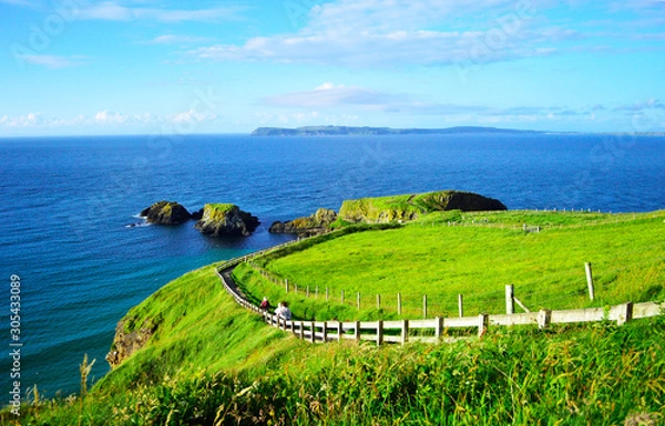 Fototapeta People Walking at Coastline Footpath  to Carrick-a-Rede Rope Bridge, Northern Ireland.