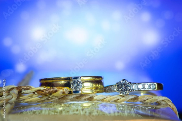 Fototapeta Wedding ring with blue background
