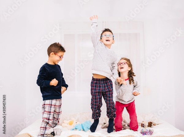 Fototapeta Children playing on a bed.