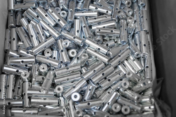 Fototapeta Steel sleeve. Details made lathe. Obtained on a lathe from steel and cast iron. Shallow depth of field. Parts stacked for further processing. Galvanized, coated part for anti-corrosion. Machined pipe