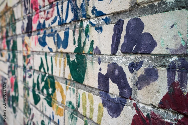 Fototapeta Wall with handprints on a playground.