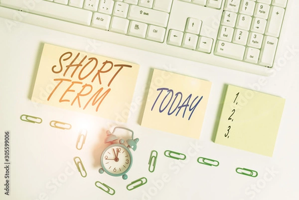 Fototapeta Handwriting text Short Term. Conceptual photo occurring over or involving a relatively short period of time Empty orange square papers and clock by the pc keyboard with copy space