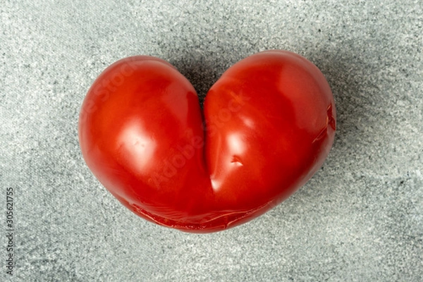 Fototapeta Ugly Organic Vegetable - Single red heart-shaped tomato on a gray background
