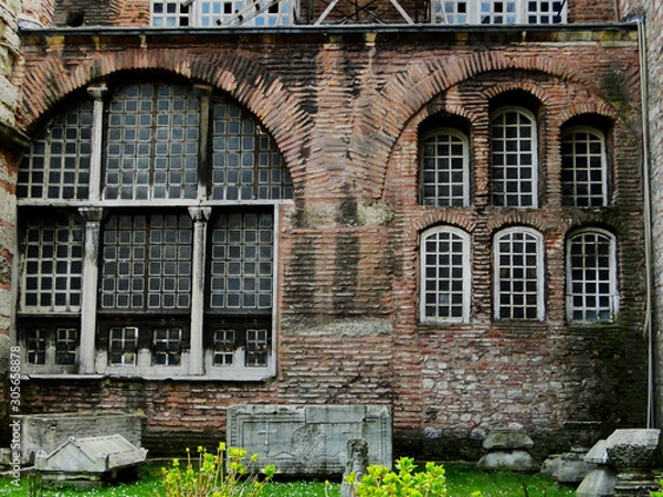 Fototapeta Red bricks wall of Hagia Sophia church in Istanbul in Turkey with remained historical biblical art wares in the garden. 2010-3