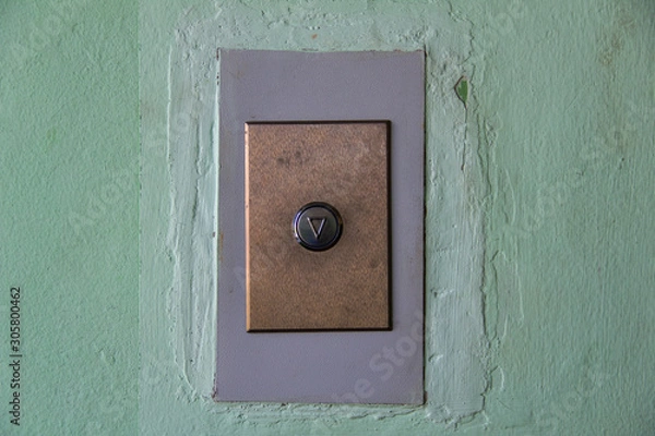 Fototapeta modern elevator arrow button on old shabby wall