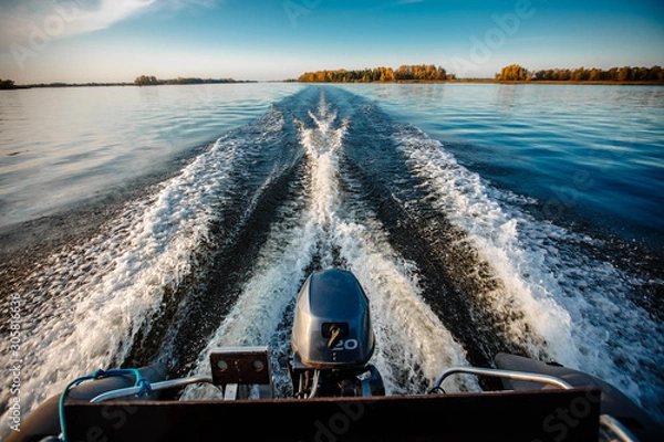 Obraz Deep river. Crossing from coast to coast. Very beautiful path on the water behind the stern of the boat from the engine.
