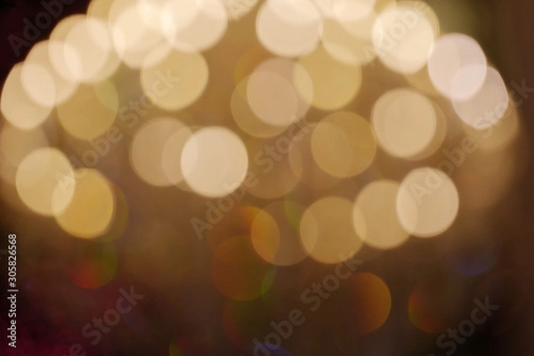 Fototapeta Gold Christmas light shiny abstract round bokeh on dark background. Colourful Glitter bokeh from blurry decoration bulbs.