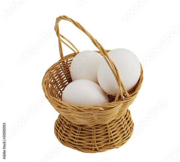 Obraz three white eggs in straw interwoven basket isolated on white