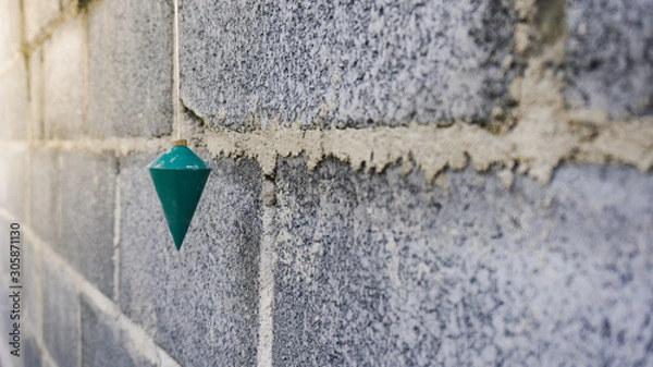 Fototapeta The construction of a plumb using a right angle measurement