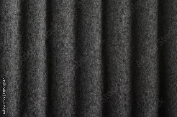 Fototapeta Black crepe paper background with vertical waves and a small pattern for your creative tasks.