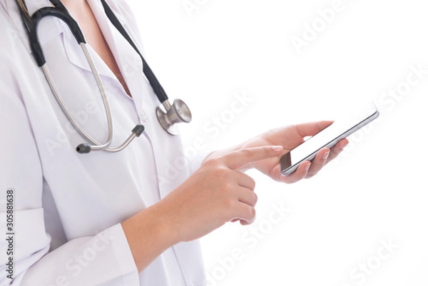 Fototapeta Portrait of female doctor using her digital tablet on white background