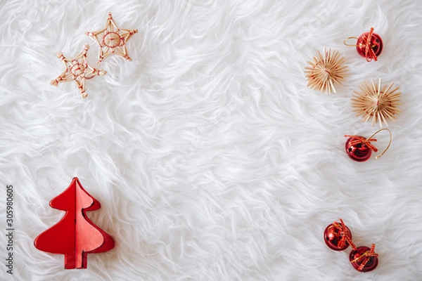 Fototapeta top view of Christmas composition on white snowy background for greeting card. wood tree decoration and little christmas red balls