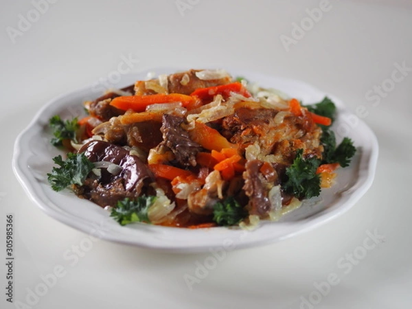 Obraz rabbit stew with vegetables on a white table
