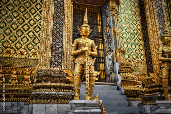 Fototapeta Beautifully stunning gold statue of a Kinnara, a beloved mythical half-human, half-bird creature on the Upper Terrace of Wat Phra Kaew or Temple of the Emerald Buddha in the Grand Palace in Bangkok