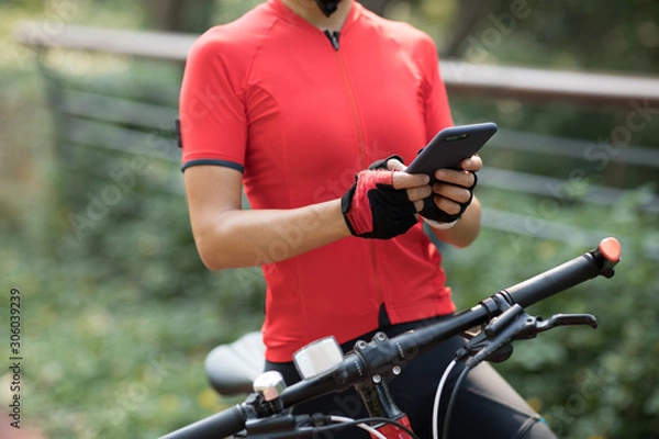 Fototapeta Riding on bike path,using smartphone while riding bike on sunny day