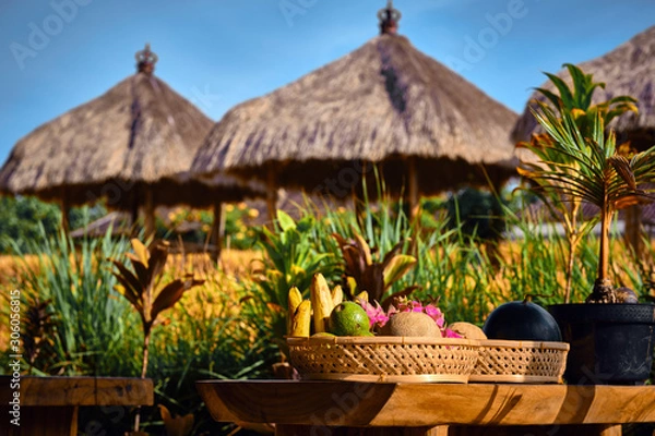 Obraz Fresh fruits on a plate in Interior of a traditional Balinese cafe in a rice field. Ubud, Bali, Indonesia.