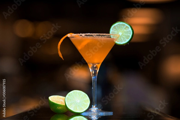 Obraz orange cocktail topped with lime slice