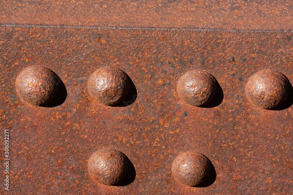 Obraz Six sunny rusty bolts head of a steel footbridge and their shadow on a rusty beam. Centered at the bottom of the image.