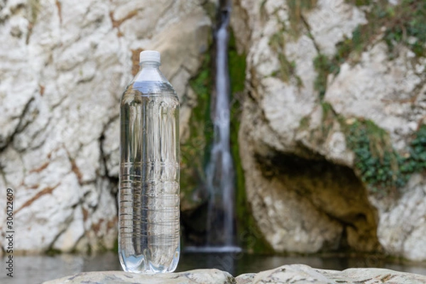 Obraz Big fresh water bottle on the background of the waterfall. Spring Water Images