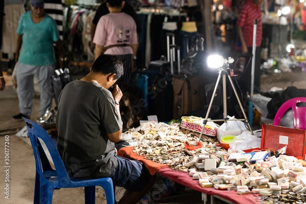Obraz man watching amulets on amulet market