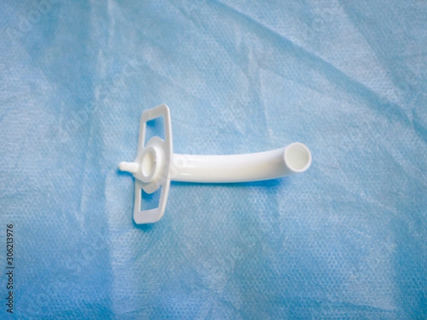 Fototapeta Tracheostomy tube close-up. For emergency care, help close-up. View from above. operation and medicine. Surgeon's tool. scissors closeup. Tracheostomy and laryngeal intubation