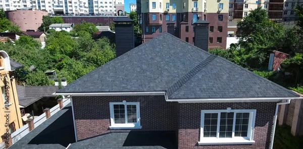 Fototapeta Bituminous tile for a roof. House with a roof from a bituminous tile. a roof from a bituminous tile. Moder
