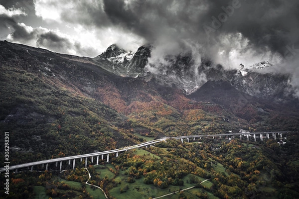 Fototapeta High autumn alpine speed road in Italia. Aerial view from above with clouds on the background