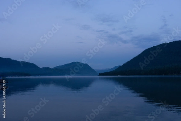 Fototapeta Lake Teletskoye in the mountains. In the evening you can see the hills and nature. Altai region
