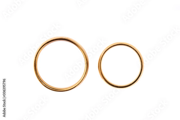 Fototapeta Two golden wedding rings isolated on white, wedding rings background concept