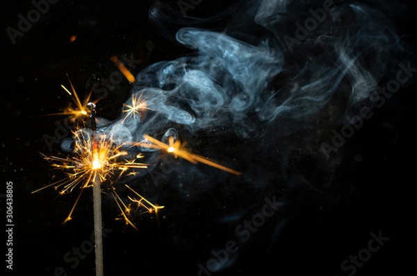 Obraz sparkler on black background with smoke
