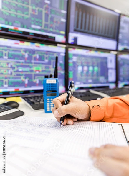 Fototapeta female hands with pen writing on notebook for report control panel in oil and gas process background.