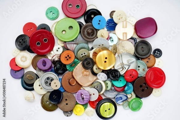 Obraz Many different buttons on a light background. Selective focus. Home needlework