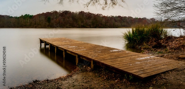 Obraz Empty wooden dock leading into a smooth lake